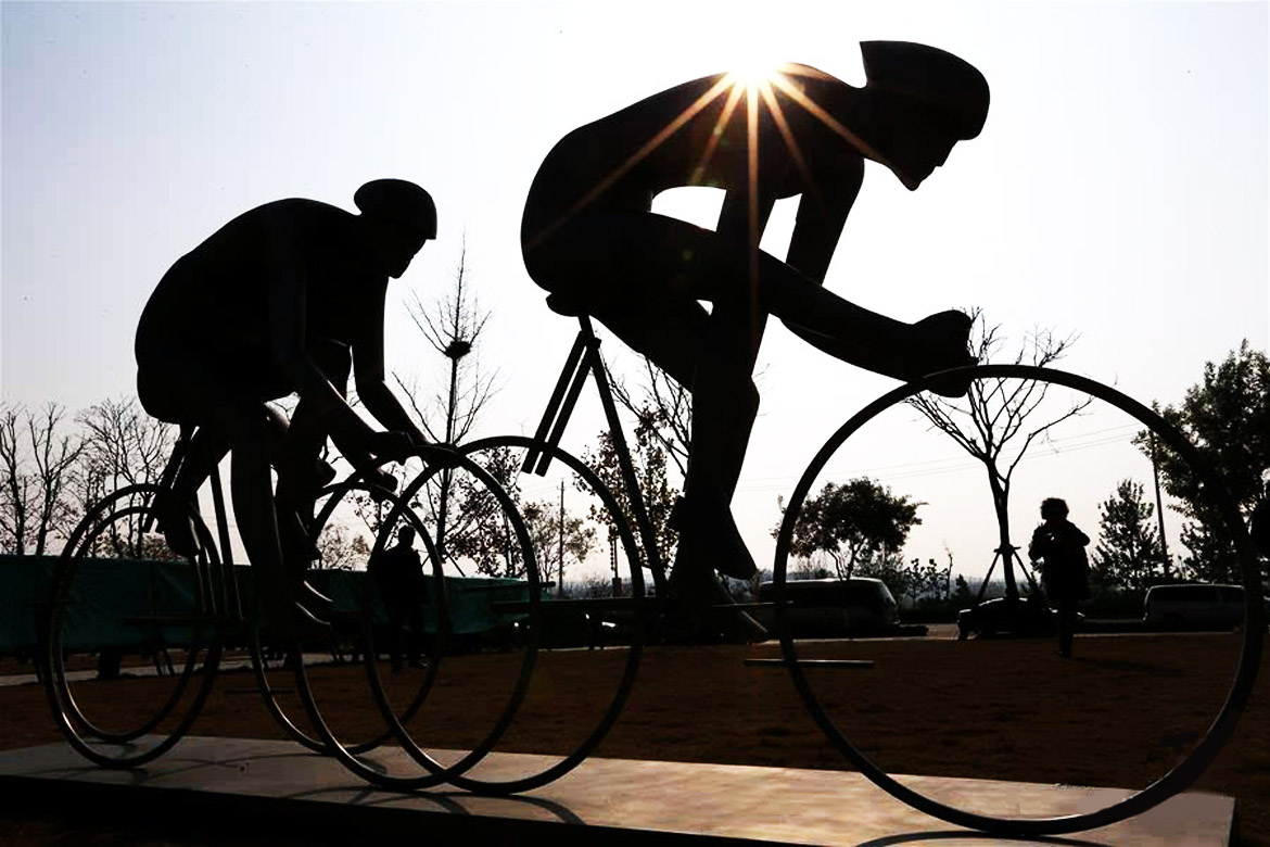 自行车追梦系列锻铜广场雕塑逆光